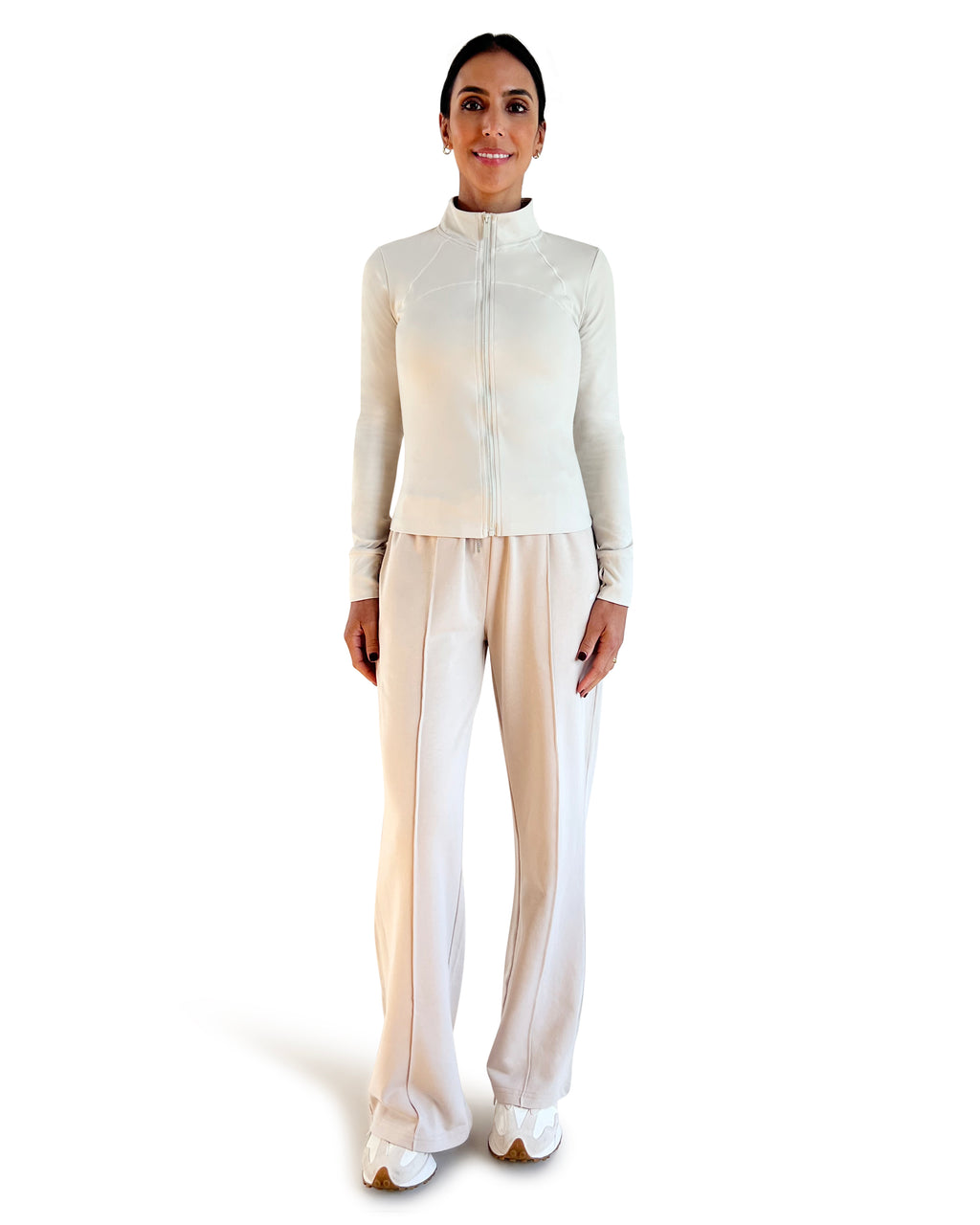 Beige cotton wide leg lounge pants with elastic waistband, side pockets and relaxed full-length fit, styled with a racerback sports bra for effortless athleisure wear.