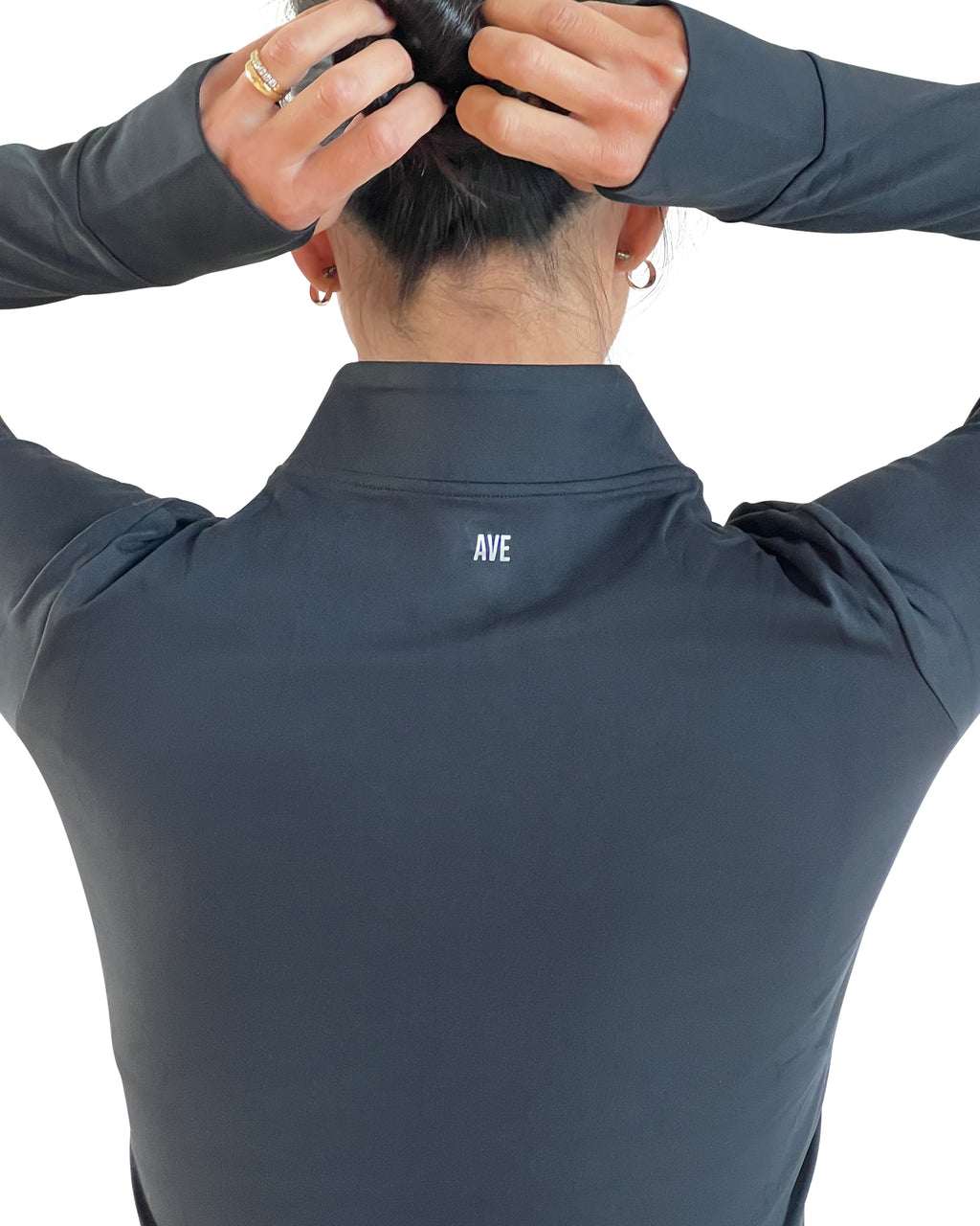 Women's black full-zip activewear jacket with thumbholes, four-way stretch fabric, and a flattering fitted silhouette for training, running, travel, and everyday wear.