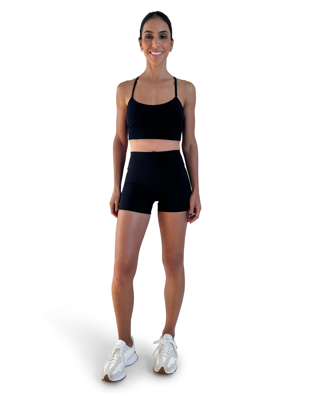 Women's black longline sports bra featuring a scoop neckline, slim straps and supportive underband, designed for yoga, Pilates and everyday athleisure wear.