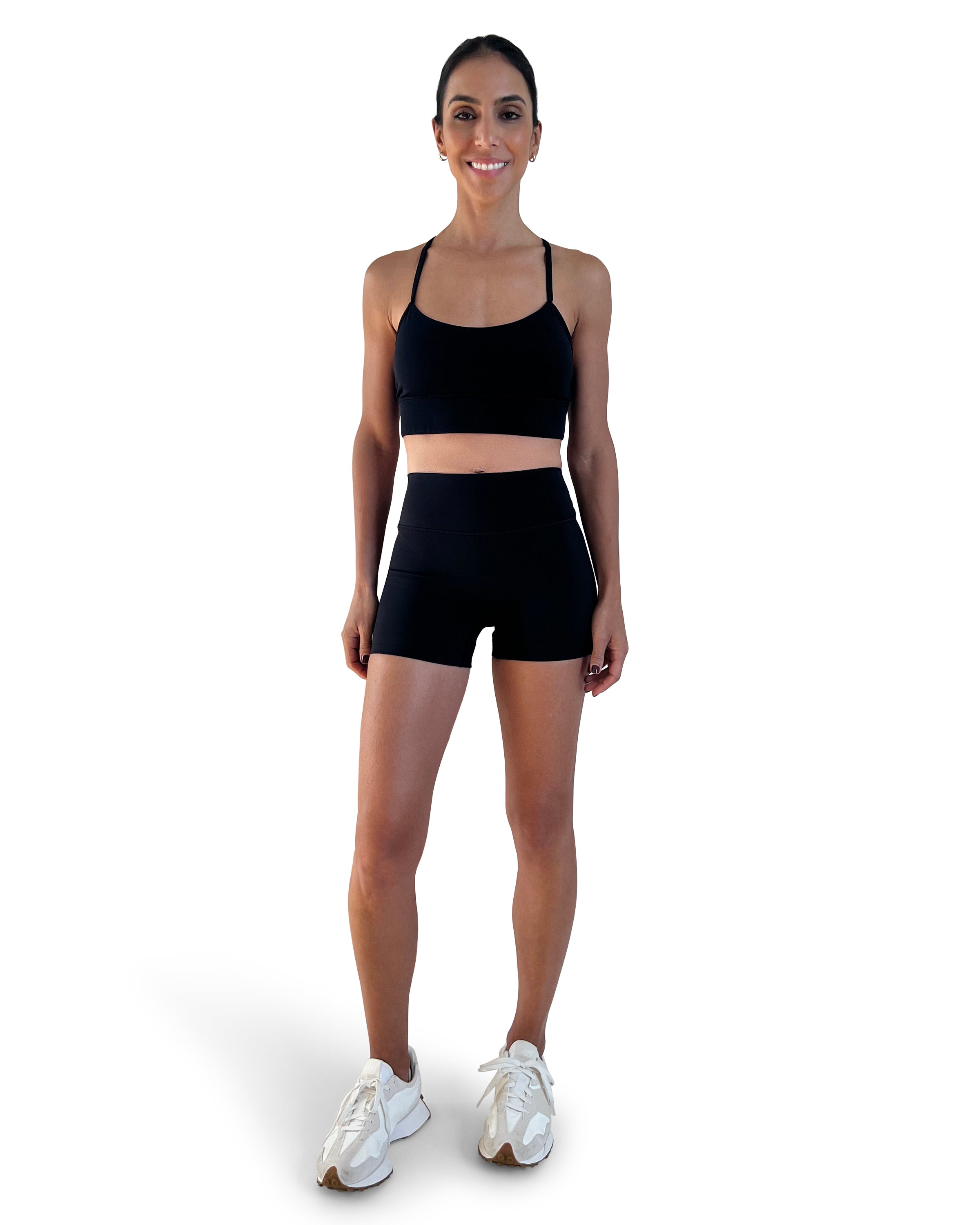 Women's black longline sports bra featuring a scoop neckline, slim straps and supportive underband, designed for yoga, Pilates and everyday athleisure wear.