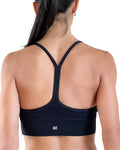 Women's black longline sports bra featuring a scoop neckline, slim straps and supportive underband, designed for yoga, Pilates and everyday athleisure wear.