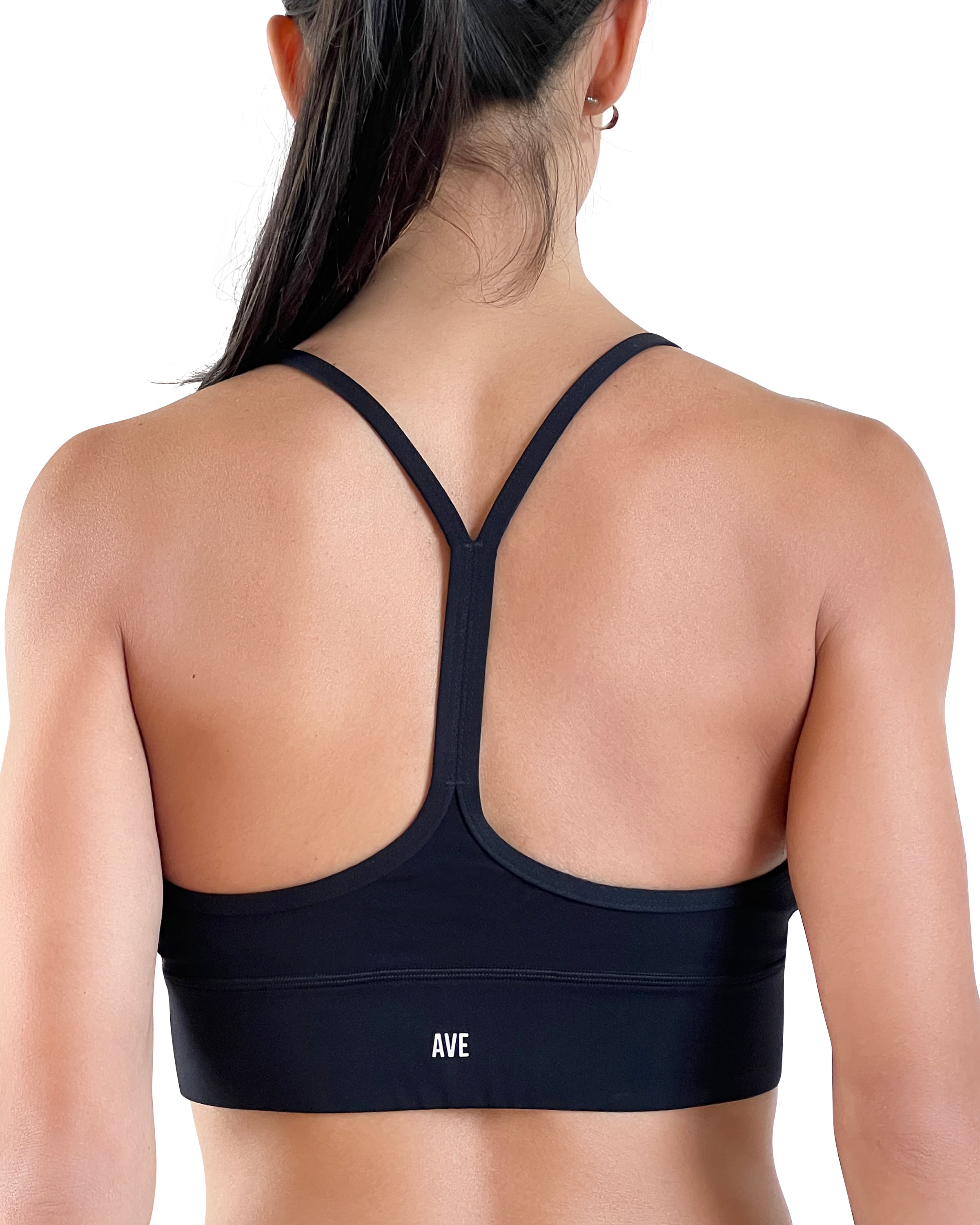 Women's black longline sports bra featuring a scoop neckline, slim straps and supportive underband, designed for yoga, Pilates and everyday athleisure wear.
