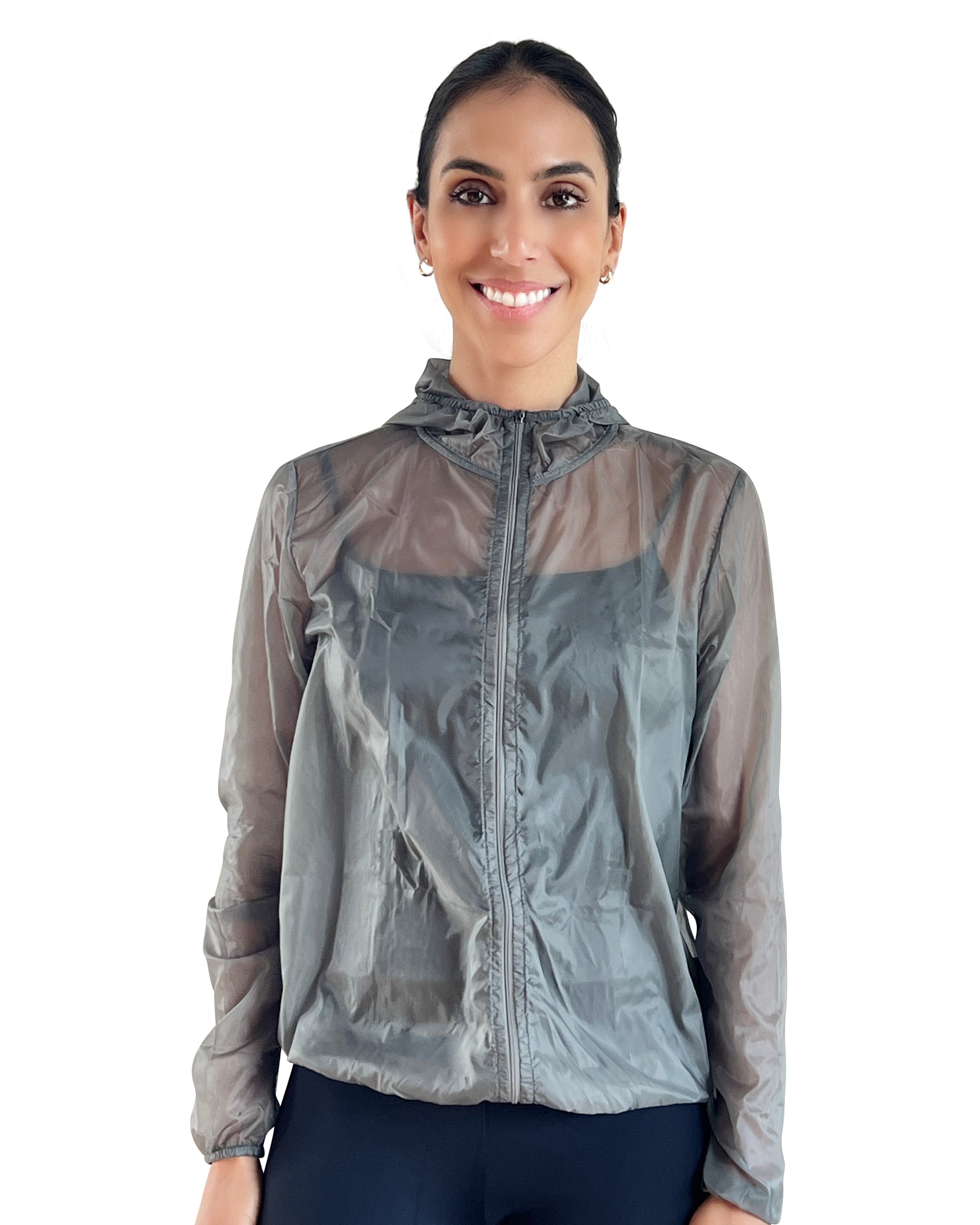 Women's grey lightweight windbreaker jacket with hood, breathable performance fabric, and packable design for travel, walking, and outdoor workouts.