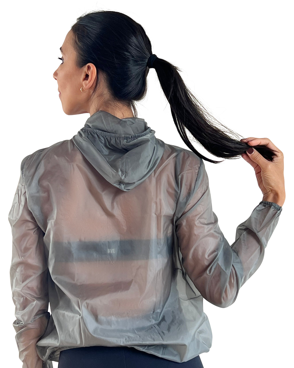 Women's grey lightweight windbreaker jacket with hood, breathable performance fabric, and packable design for travel, walking, and outdoor workouts.