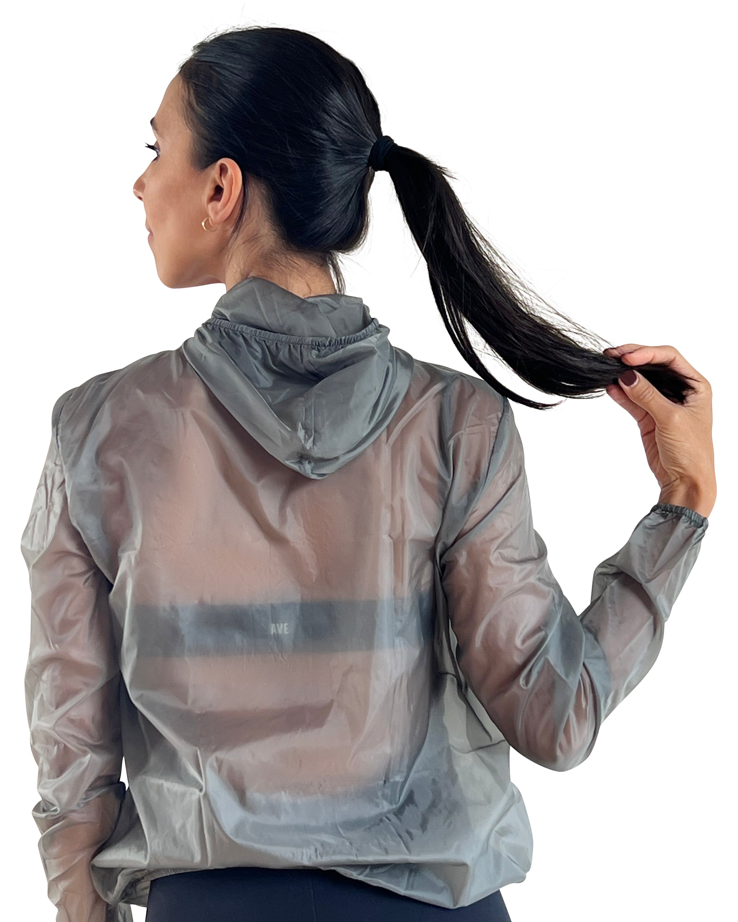 Women's grey lightweight windbreaker jacket with hood, breathable performance fabric, and packable design for travel, walking, and outdoor workouts.