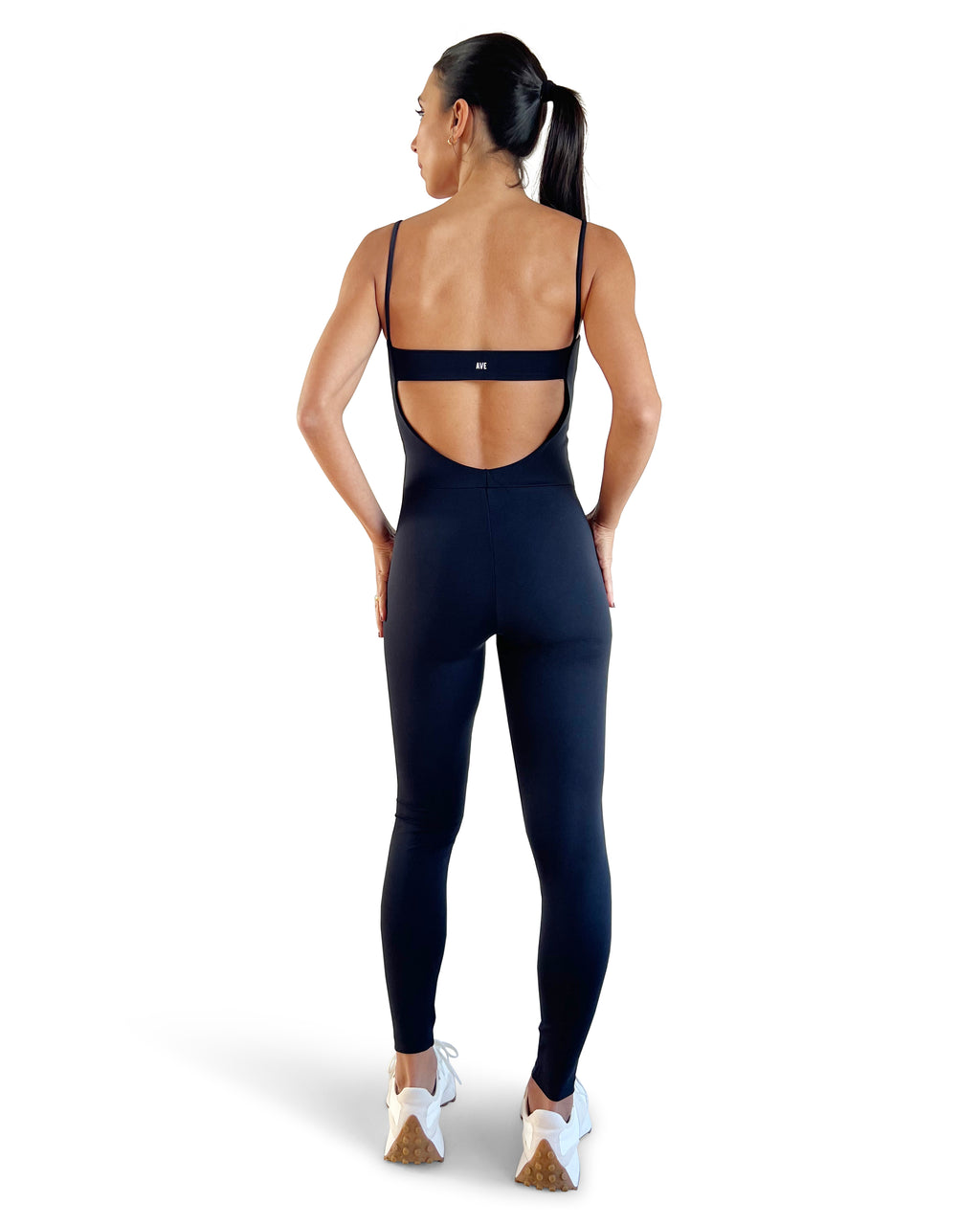 Women's black open-back activewear jumpsuit with sculpting compression fit, full-length leggings and minimalist strappy back design by AVE.